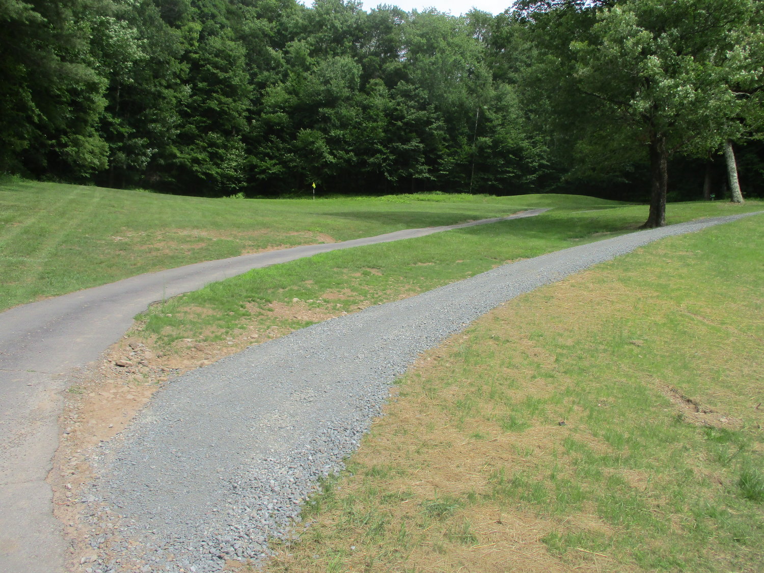 A new cart path, right, replaces an old path, left, on the 4th hole at Twin Village Golf Course with the new path taking you to the fifth tee and a cart path to the fifth fairway.