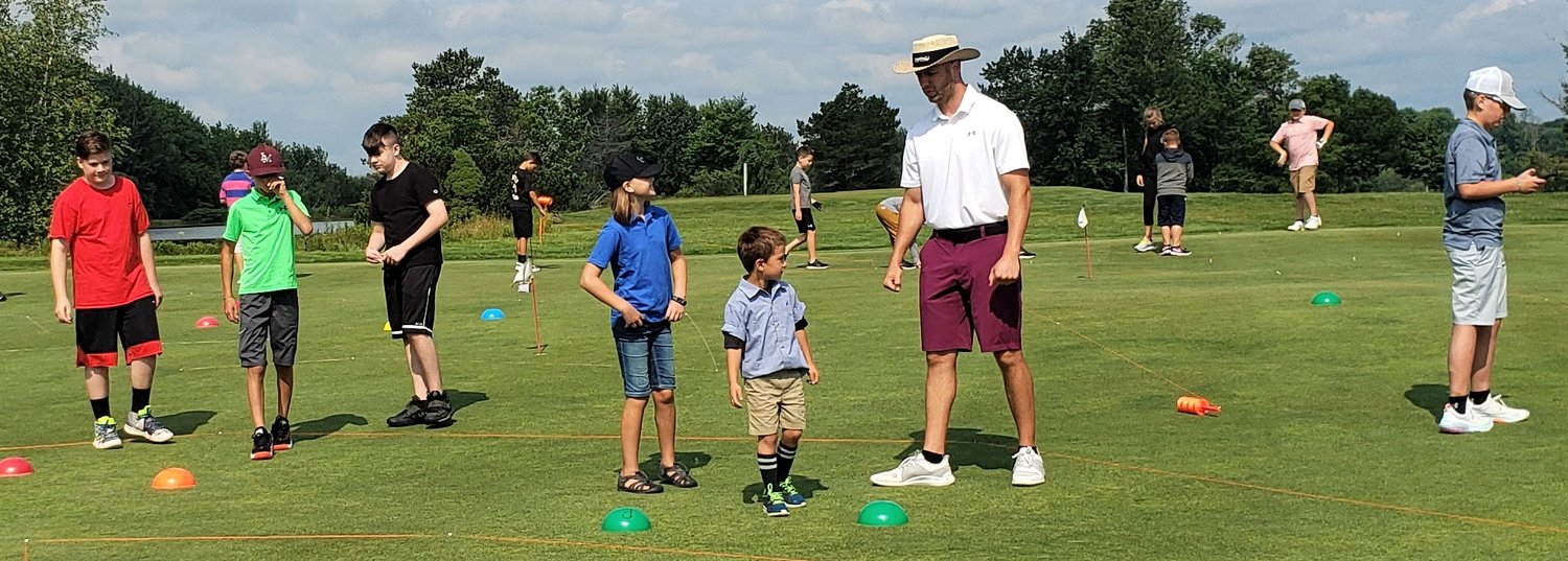 Instructor Joe Franke gives Swan Lake Golf & Country Club campers golf instructions.