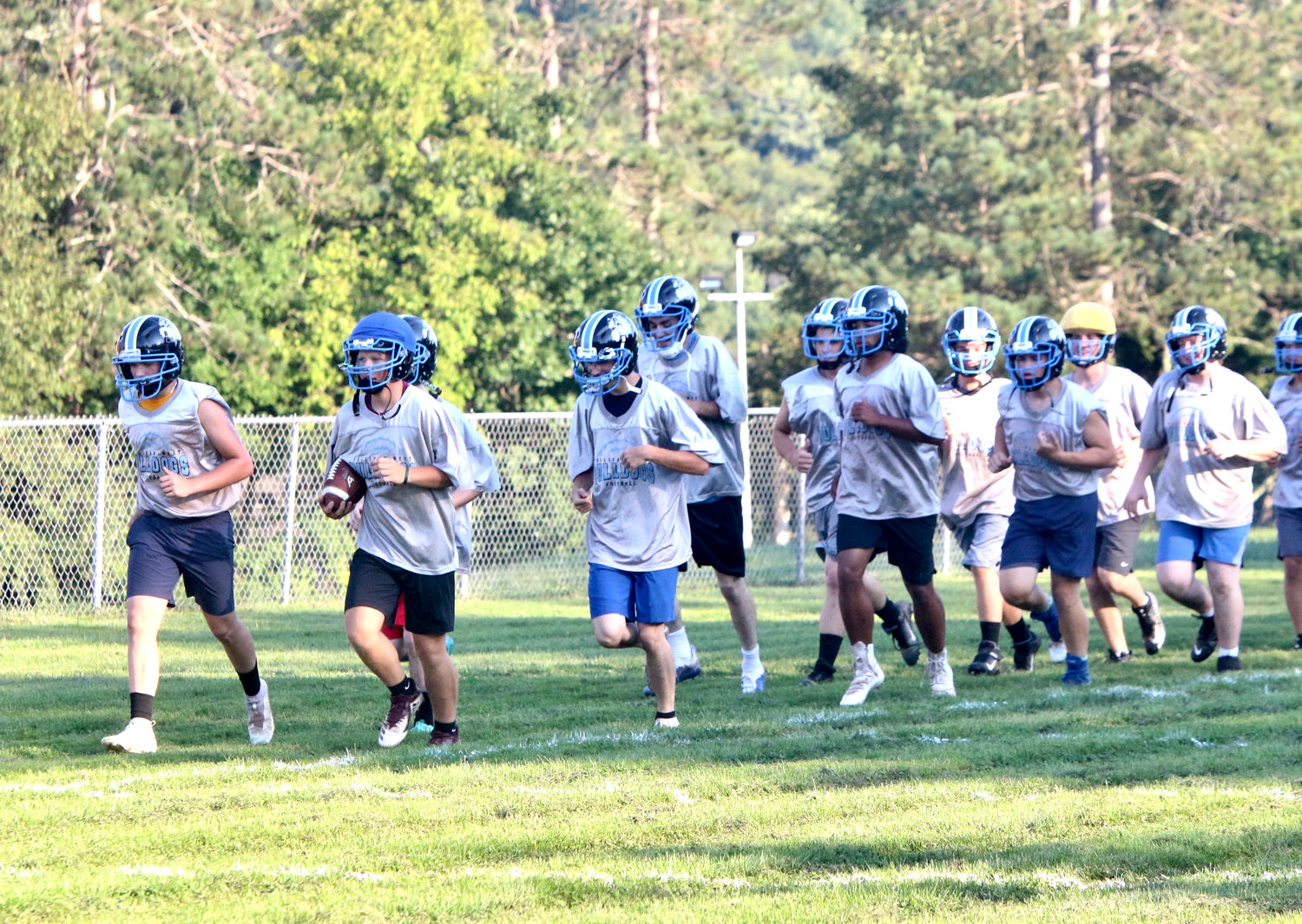 No matter what the sport, conditioning is key so it was a universal sight to witness teams running laps around the field. Here the Sullivan West Bulldogs football team begins their practice with laps around the practice field in Jeffersonville.