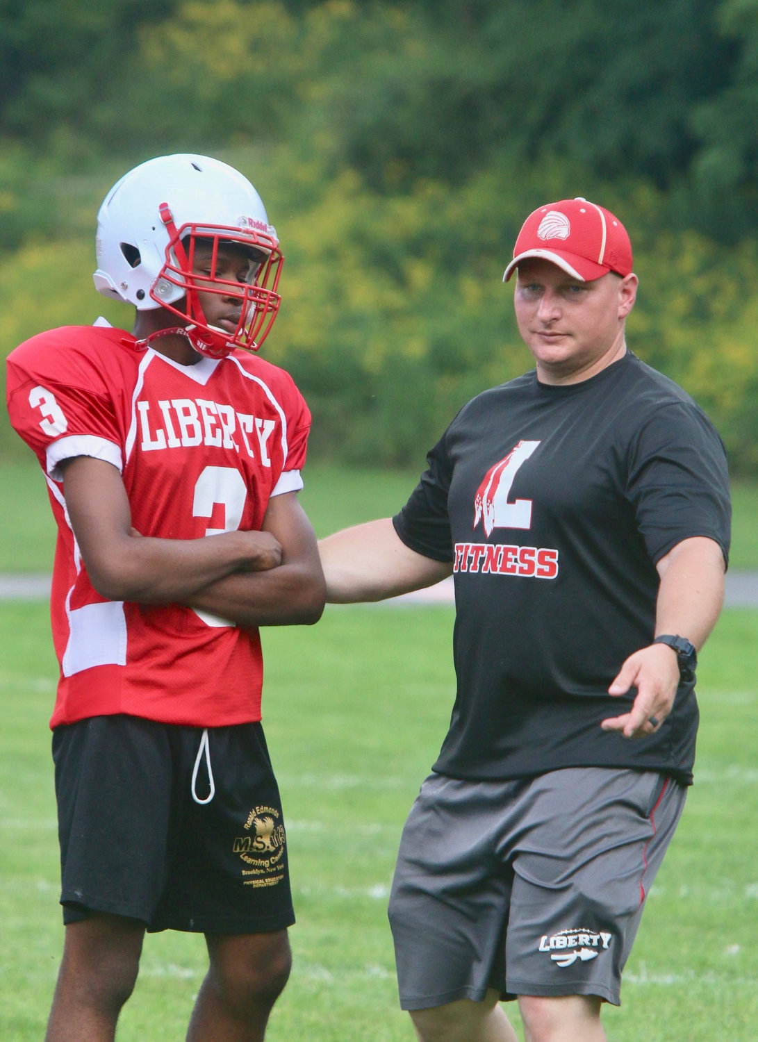 Liberty head football coach counsels junior running back/cornerback Giovanni Dudley on a kickoff drill. A clap of thunder mandated a quick exit from the field but when the skies cleared the Indians were right back at it. Look for a resurgence of Liberty Indians football under the tutelage of newly appointed head football coach Adam Lake.