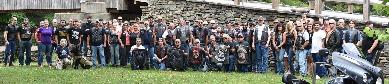 Those taking part in the memorial motorcycle poker run August. 14 pose for this photo.