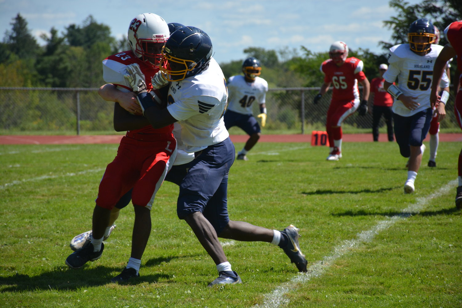 Liberty's Giovanni Dudley (left) fights for a few extra yards.