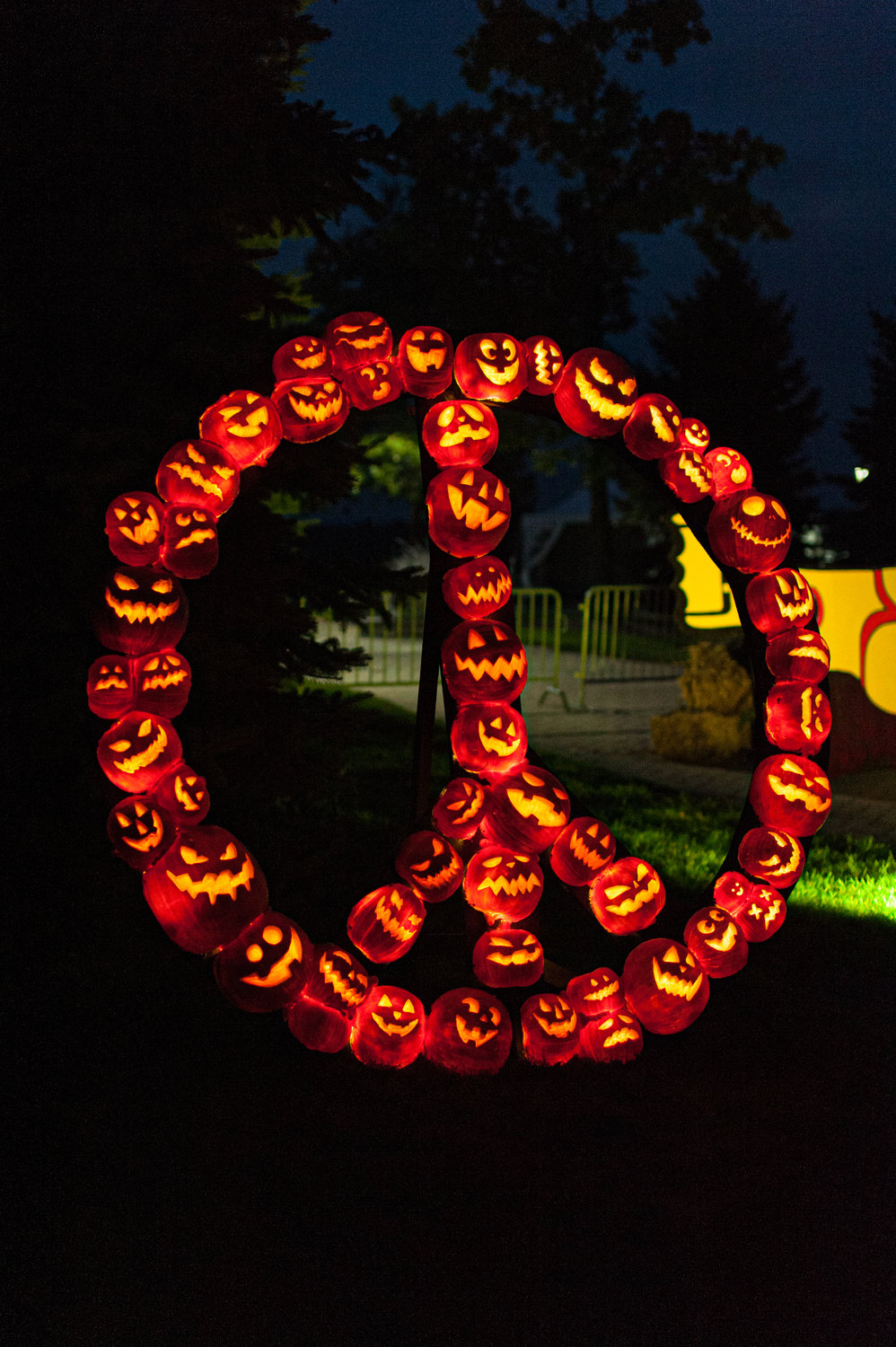 Glowing and groovy Woodstock pumpkin art on display.