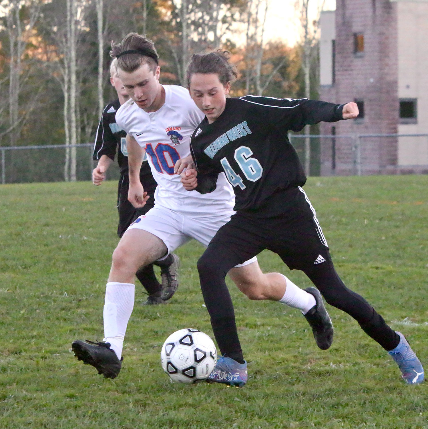 Sullivan West’s Nic Perez vies for control of a ball in midfield against Seward’s Cole Buchalski.