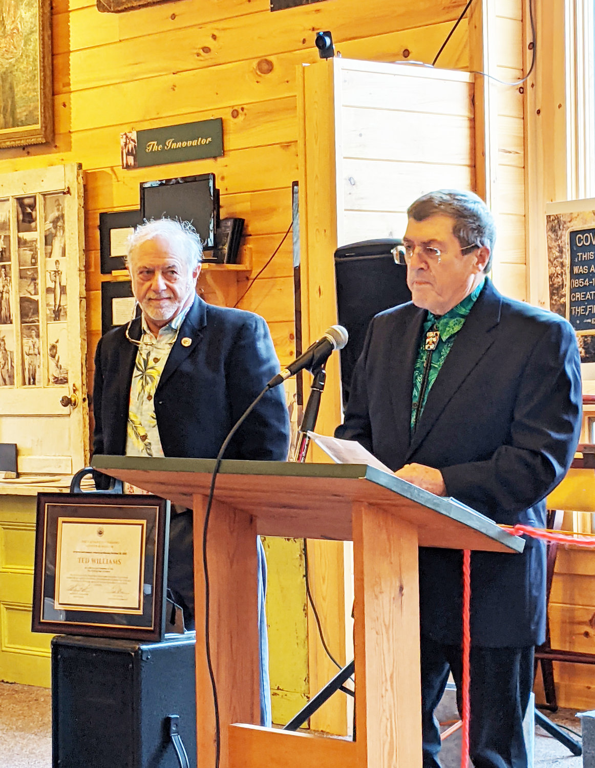 Terry Schultz (at mic) shares information about 2021 Hall of Fame inductee Ted Williams at the Catskill Fly Fishing Center and Museum ceremony while Ted Patlen looks on.