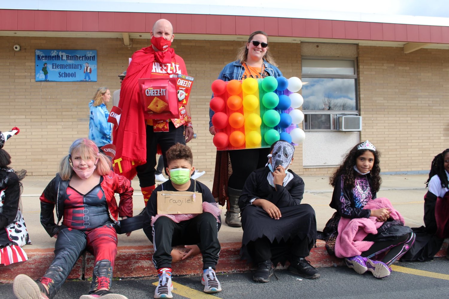 "Some students thought KLR teacher Dennis Lankau's costume was "cheesy" – but who doesn't love a Cheese-It cracker? Here he is flanked by Mrs. Elyssa Olsen in her colorful costume."