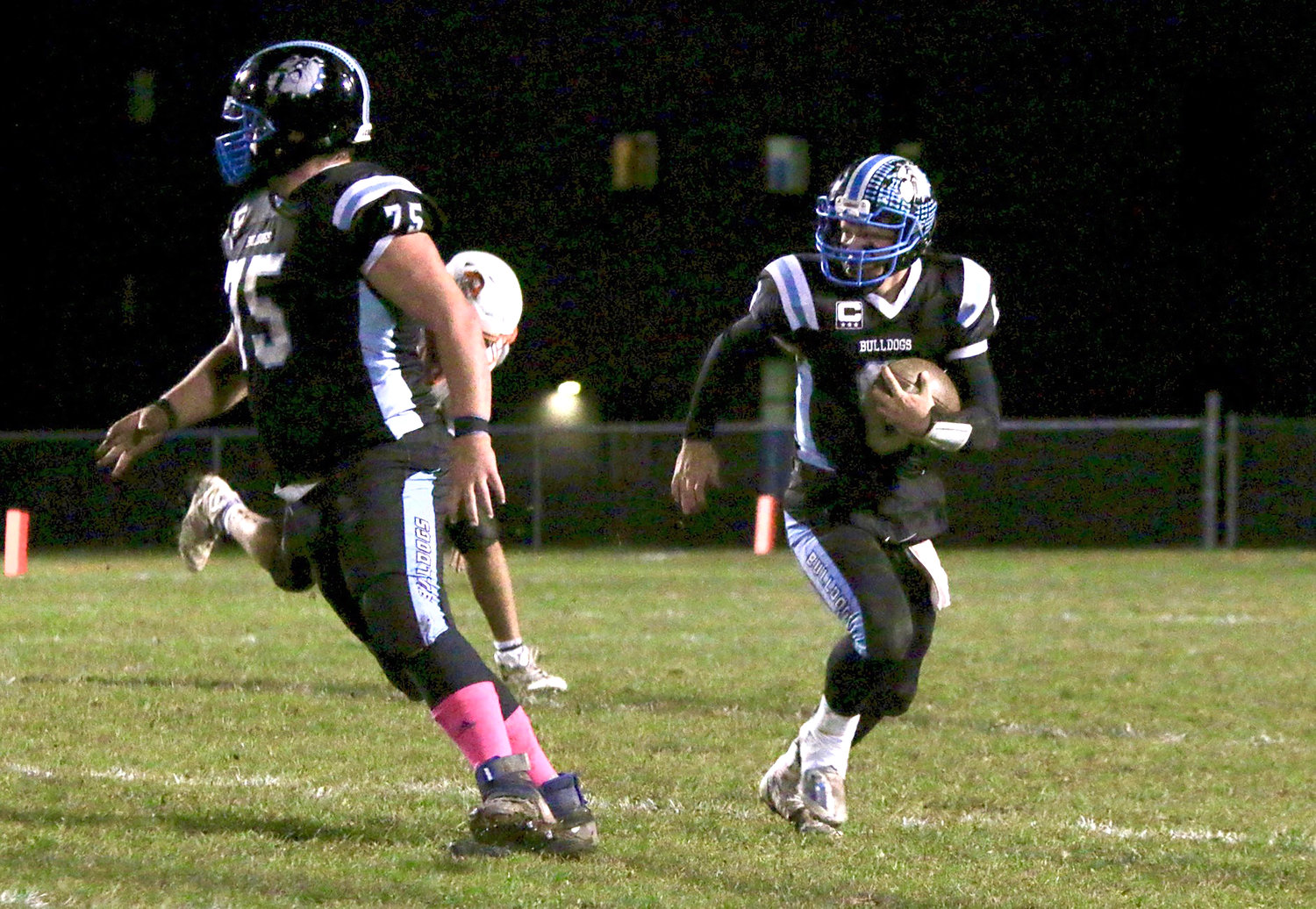 Senior quarterback Gavin Hauschild ran for three TD’s and threw for another in a break-out performance. He rushed for 150 yards. Here, he follows behind the awesome blocking of senior Chris Campanelli.