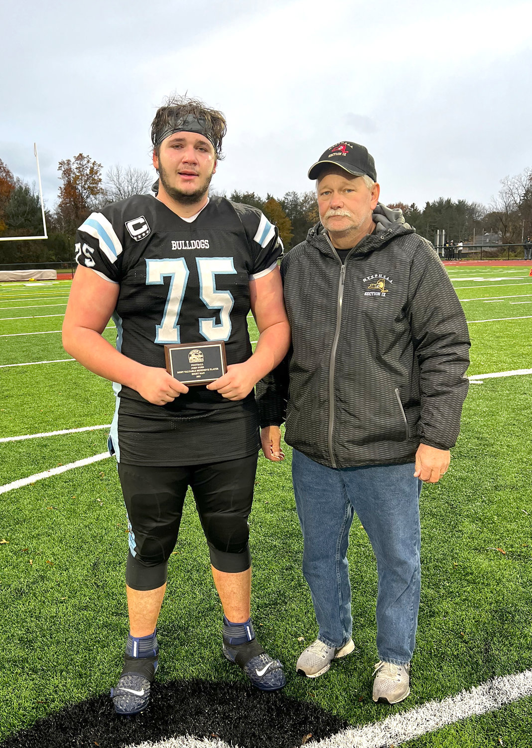 Sullivan West senior Chris Campanelli was named the Defensive MVP. He is pictured with Section IX Eight-Man Football Coordinator David Franskevicz.