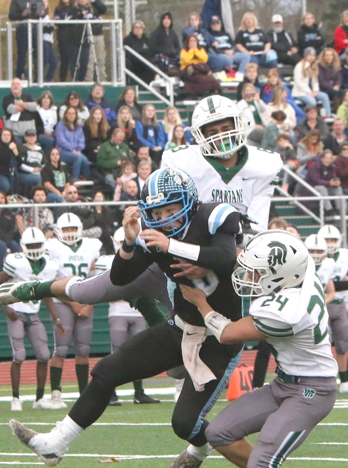 SW quarterback Gavin Hauschild goes up for a pass from Justin Grund and is sandwiched between Spackenkill's Antonio Lopez and Seven Ciancio. He badly twisted his knee and had to exit the game near the end of the second quarter.