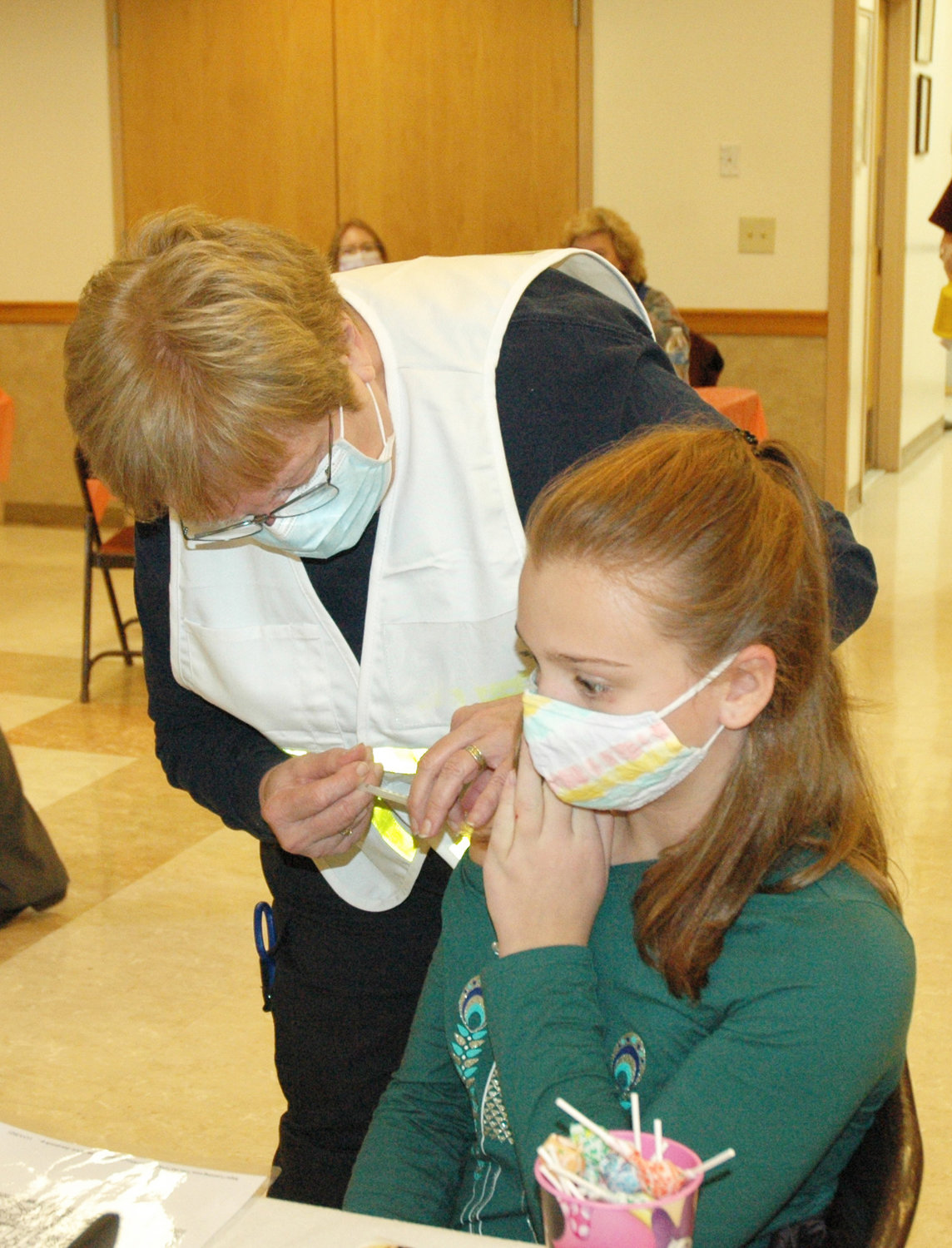 Lauren Galliean, 4th Grader, receiving the vaccination shot from Ann Bivins, EMT and volunteer from Neversink.