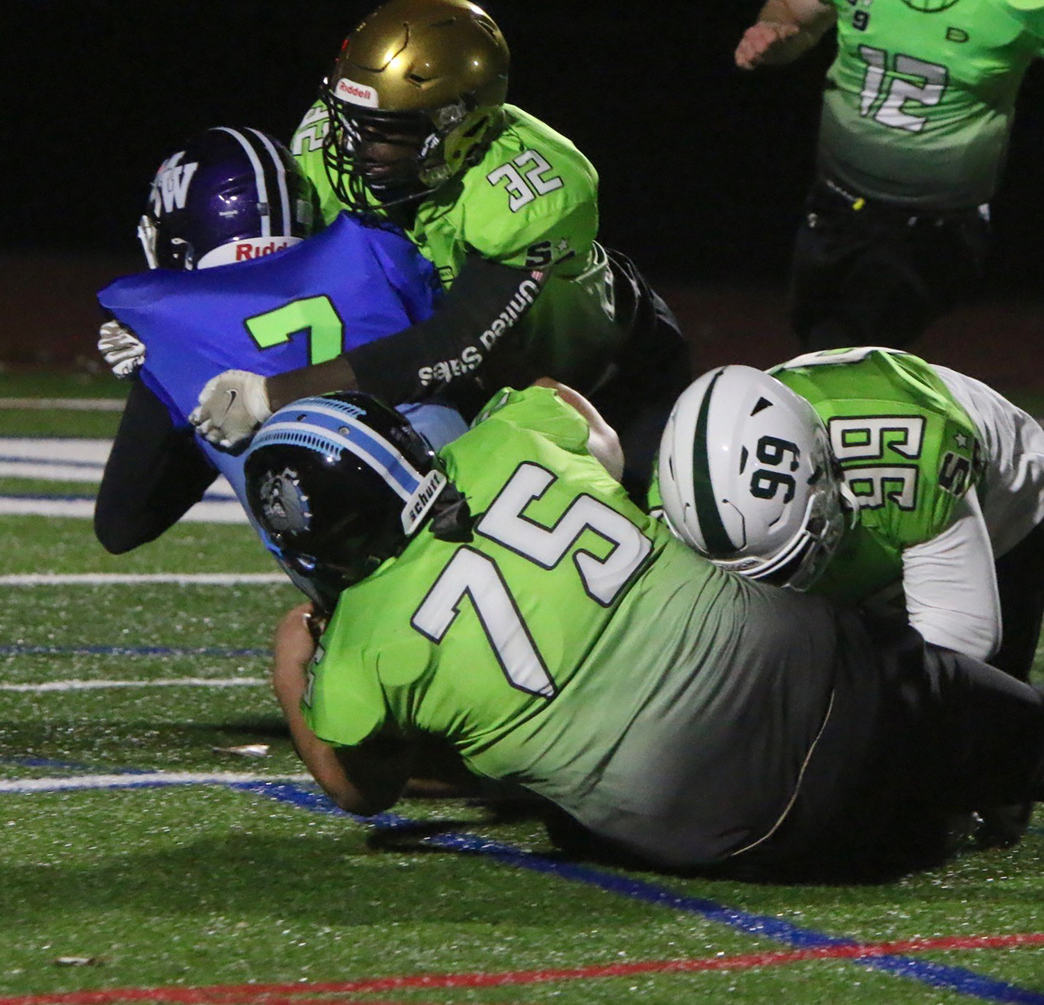 Sullivan West’s Chris Campanelli brings down Monroe-Woodbury running back Michael Zrelak. Campanelli is assisted by teammate linebacker James McGuinness from Washingtonville.