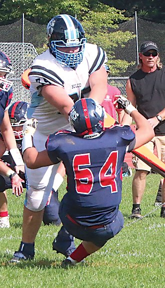 Chris Campanelli executes one of his patented 32 pancake blocks as he topples Tri-Valley’s Joseph Rodriguez in the Bulldogs’ league win over the Bears.