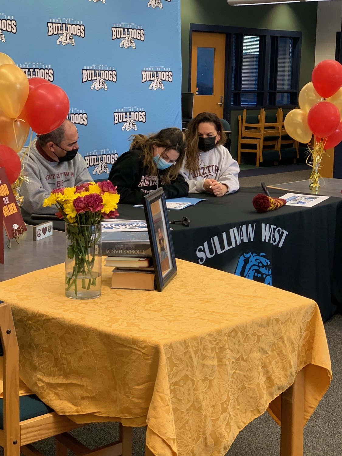 Gabby (middle) is joined by Ken (left) and Tanya Cohen(right) as she signs her letter of intent to play golf for Kutztown University. Sullivan West held an event for Gabby’s signing, in which Kutztown’s golf coach was able to join remotely.