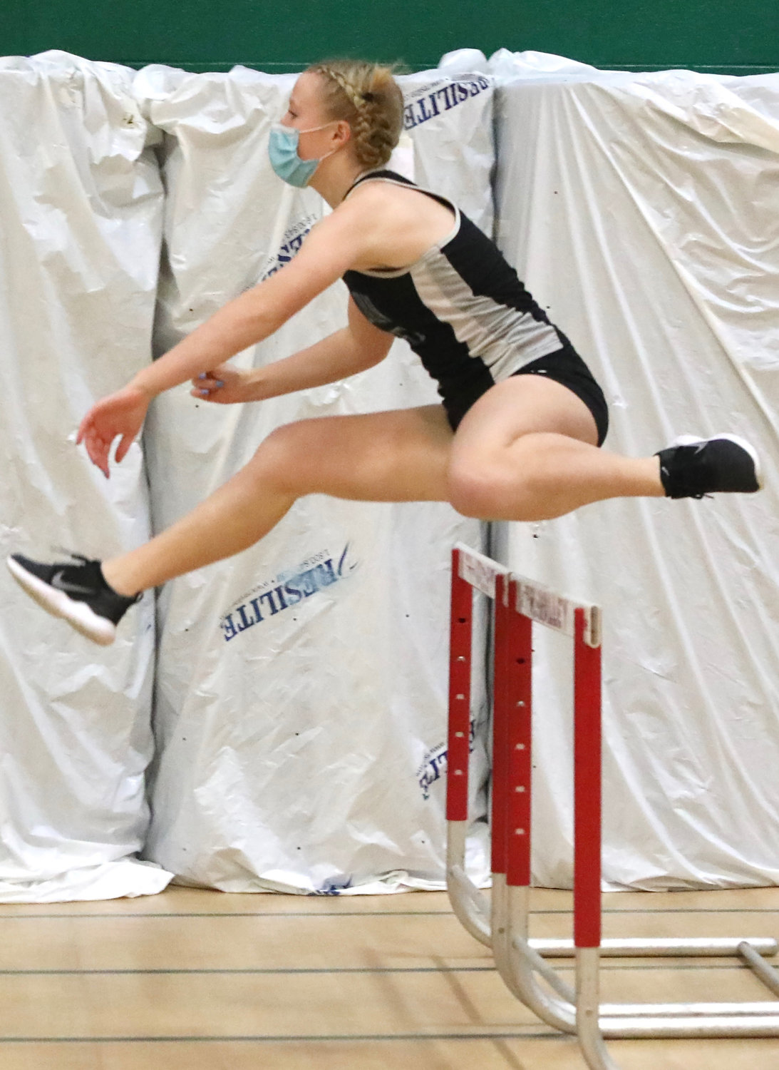 Sullivan West’s Keely Schock leaps over the 55 hurdles with good form. She followed Monticello’s Taina DeJesus, the county’s best hurdler emulating her style and technique.