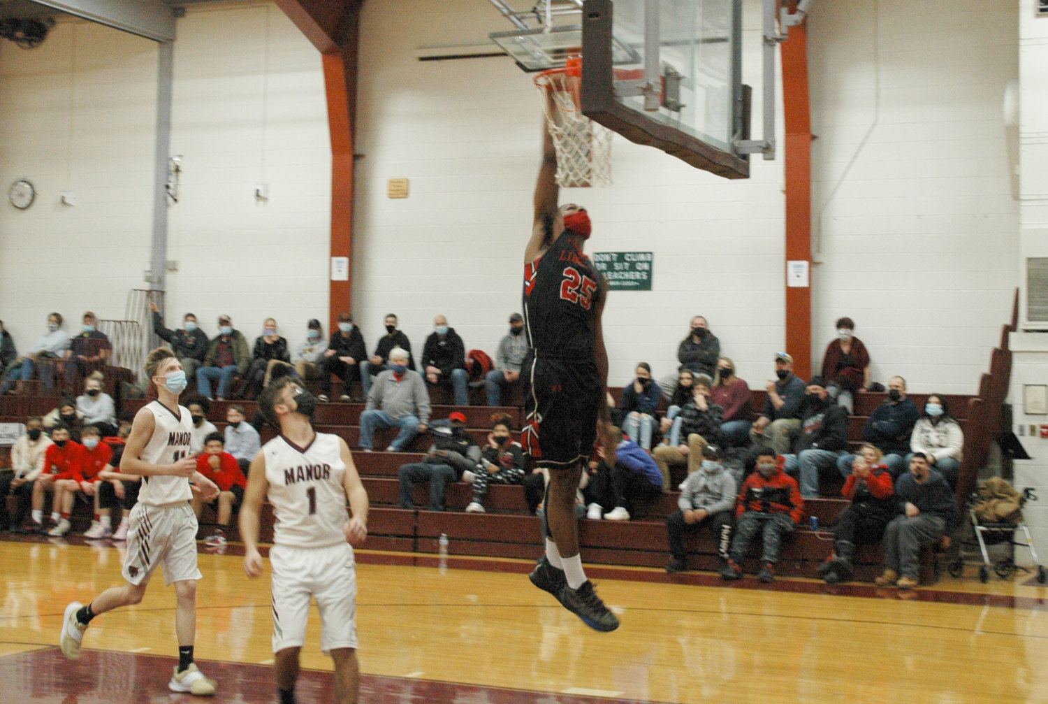 Nasir Gibbs reaches up for the one-handed dunk in a non-league win over Livingston Manor. Gibbs had 28 points in the game.