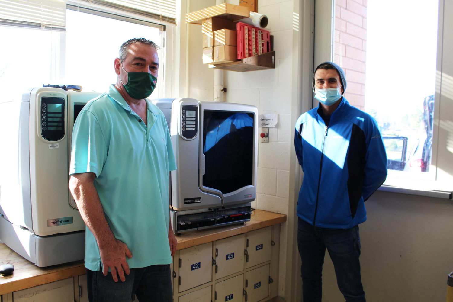 From right to left, William Oefelein and Richard Music pose with the newly-donated 3-D printer.