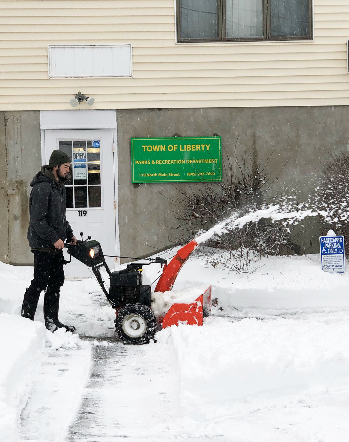Town of Liberty Park and Rec’s Matthew Brooks clears snow on Monday.