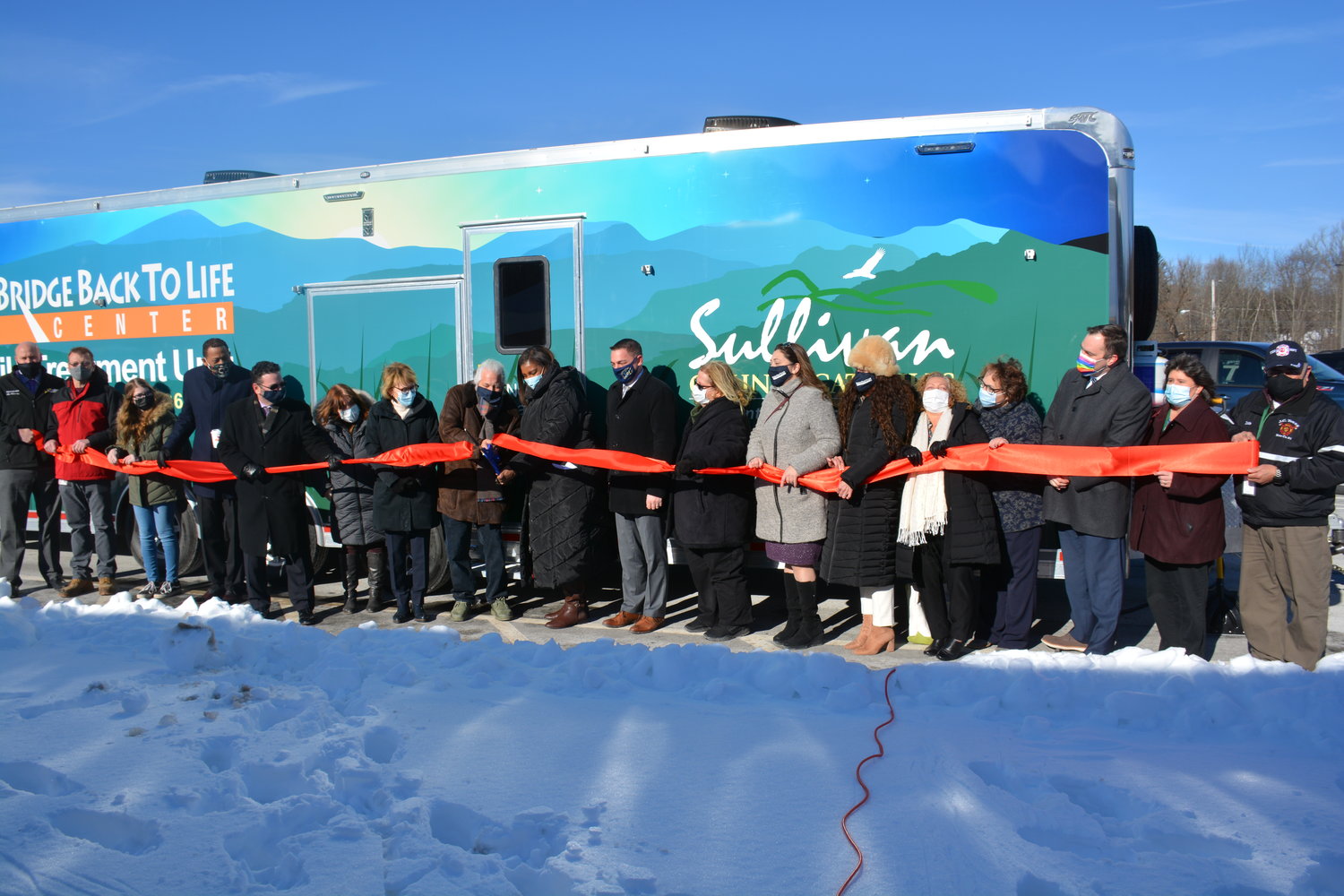 Local and state officials were on hand for a celebratory ribbon cutting on a new mobile health treatment unit on Thursday.