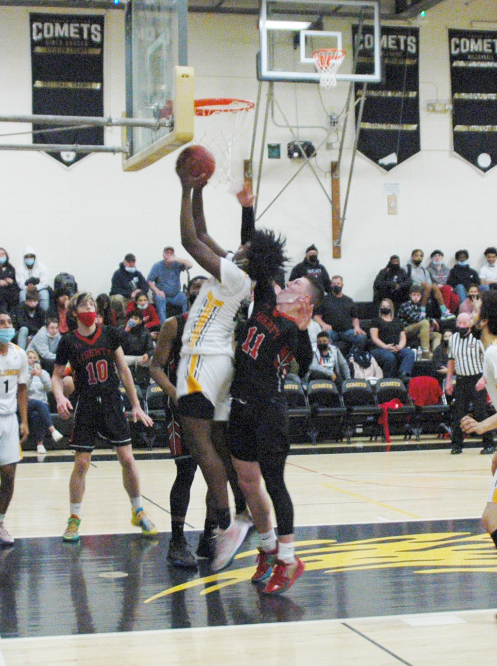 Eugene Johnson finishes through contact for two of his game-high 20 points in Thursday’s league win over Liberty.