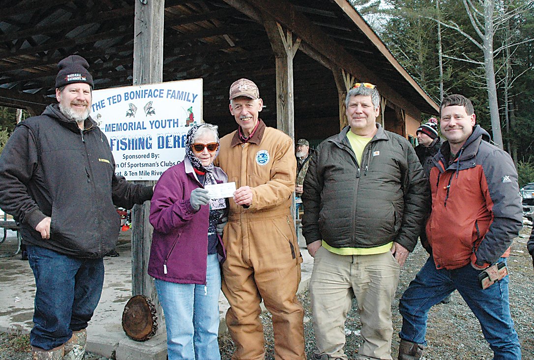 Joined by members of the Boniface Family, Barbara Boniface, center, donates a check of $1,000 accepted on behalf of the Federation of Sportsmen’s Clubs of Sullivan County by Chair of Youth Ice Fishing Chair, Carl Lindsley.