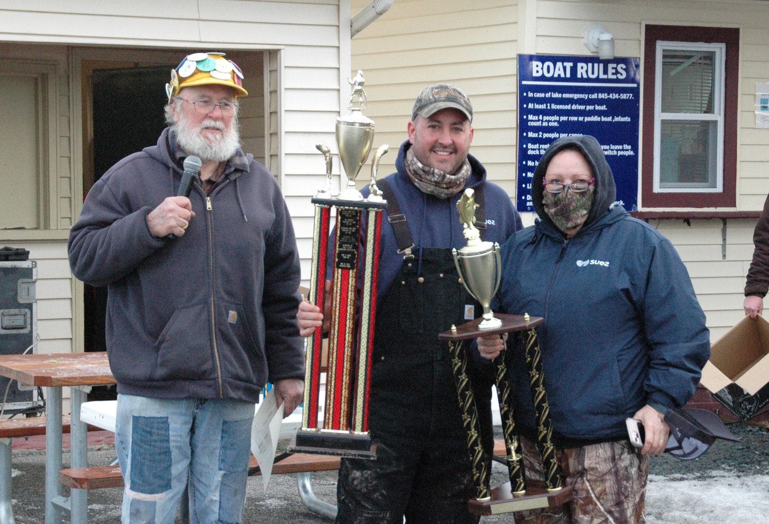 Thomas Carney (center) is presented with the first place trophy for Tappan Fire Department after winning the ice fishing contest. Event organizer, J.W. Halchak (left), presented the award.
