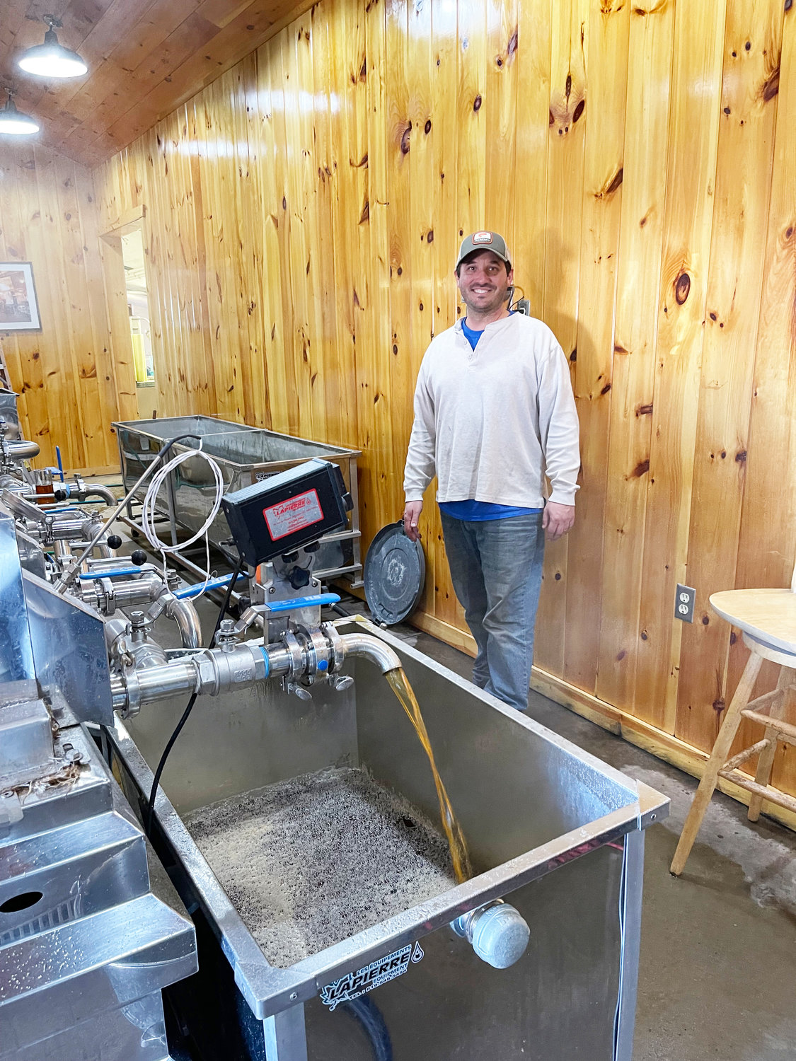 It was a busy day on Wednesday when John Garigliano and his crew made 800 gallons of maple syrup. Above, the amber syrup flows out of the Lapierre evaporater and will then be put into stainless steel barrels