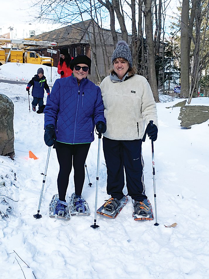 Maureen Crescitelli and Terry Delaney start out on the trail with their snowshoes.