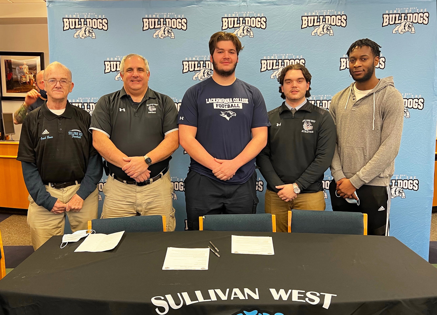 Chris Campanelli, center, is joined by his football coaches (left to right) Ron Bauer, John Hauschild, Justin Diehl and Ronj Padu.