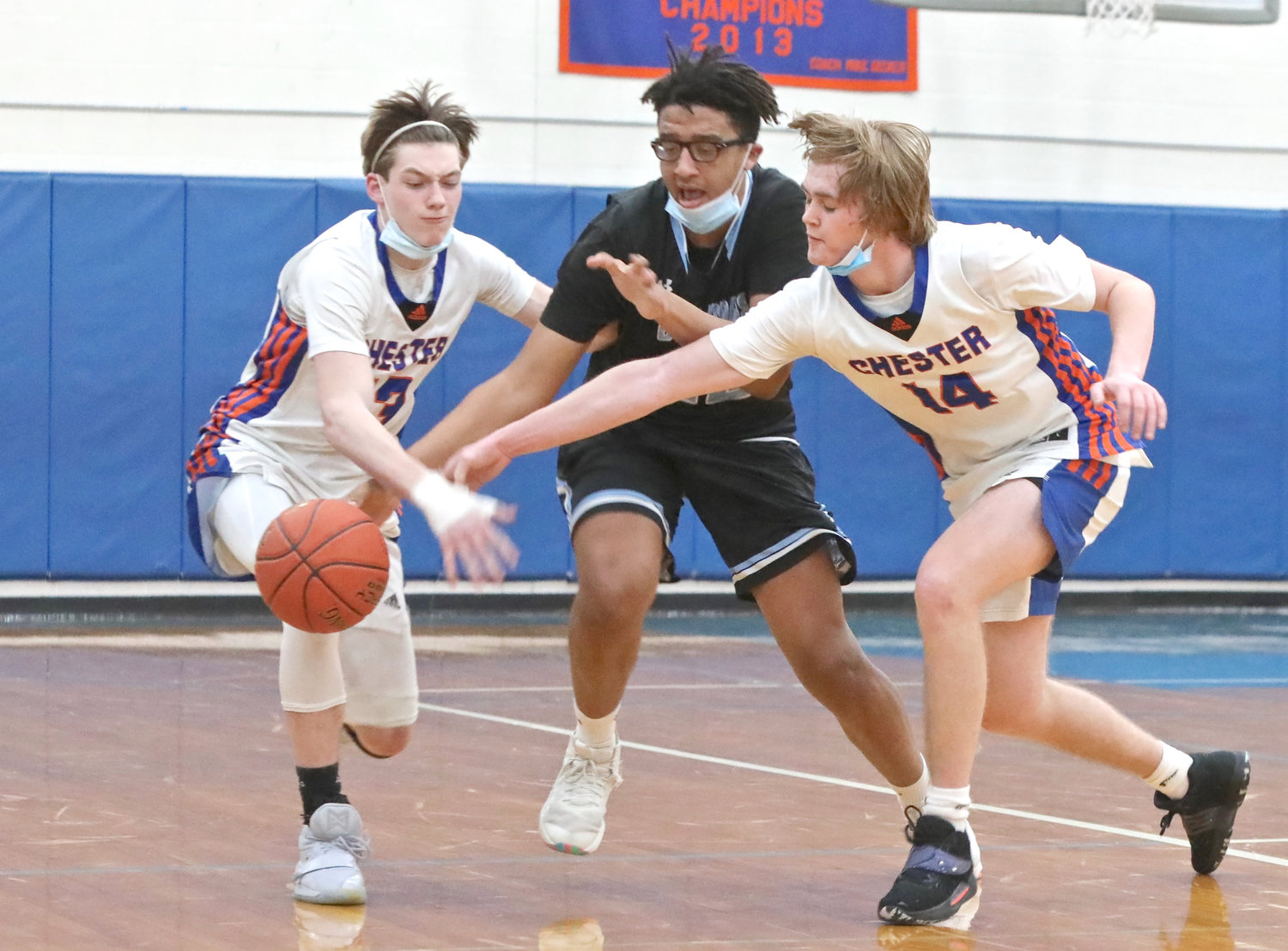 Crossfire: Sullivan West senior Tariq Gambari looks to advance the ball up the floor but is hampered by Chester’s Jimmy Lusignan (13) and Alex Bastian (14). Chester’s pressure on the ball was hard for Sullivan West to handle.