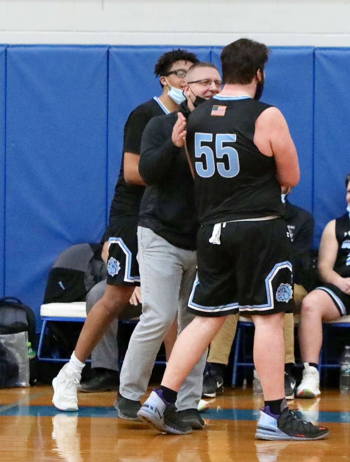 An emotional exit. Chris Campanelli leaves the game in the waning minutes and is patted on the back affectionately by coach John Meyer. The Big Fella left his imprint on SW basketball just as he did in football and will do this spring as a thrower and sometime relay runner in track.
