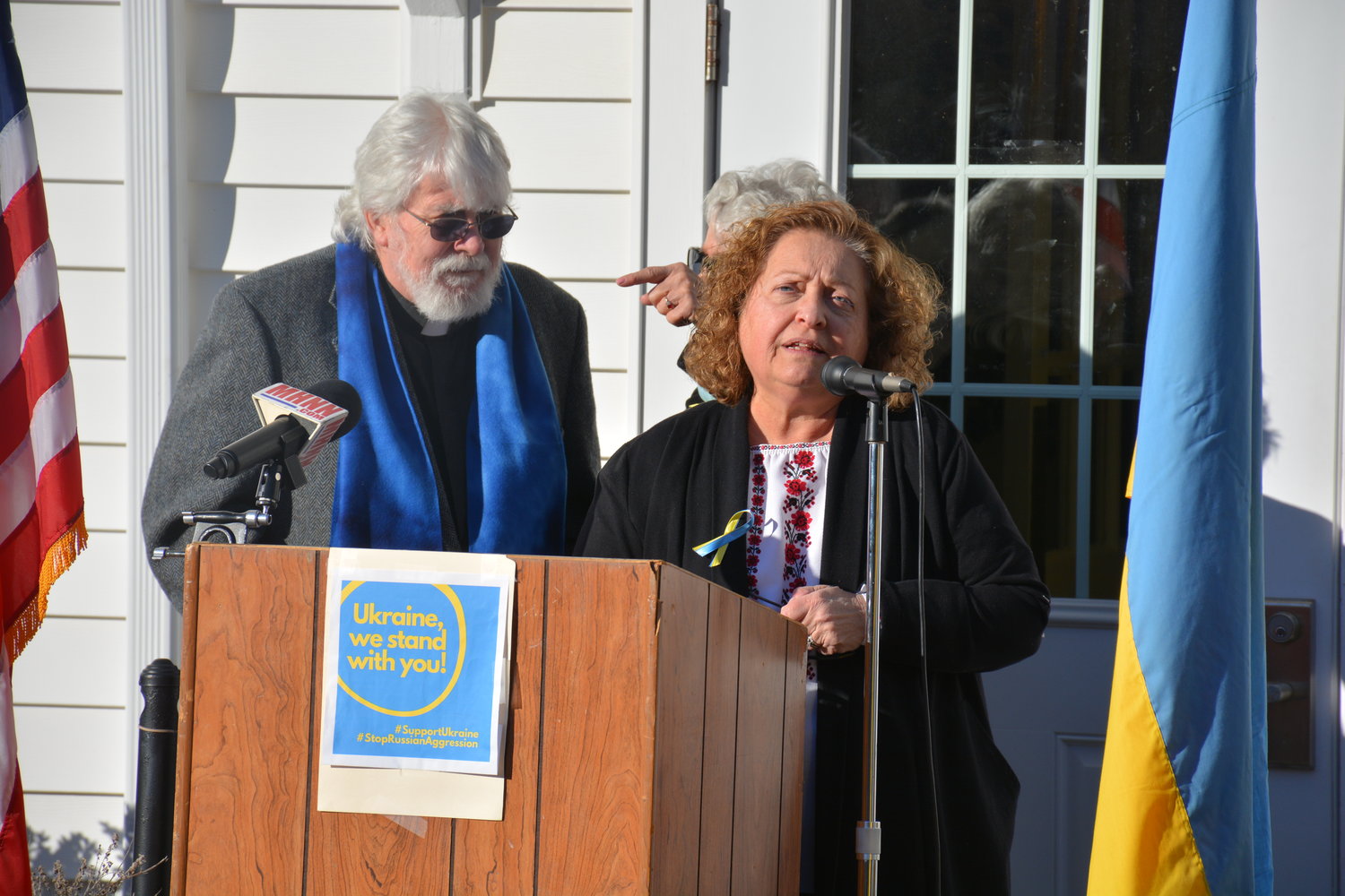 District 2 Legislator Nadia Rajsz, who is a member of the Ukrainian Congress Committee of America and president of the local branch of the Ukrainian National Women’s League of America, speaks to rally attendees. To her left is Pastor Bob Everett.