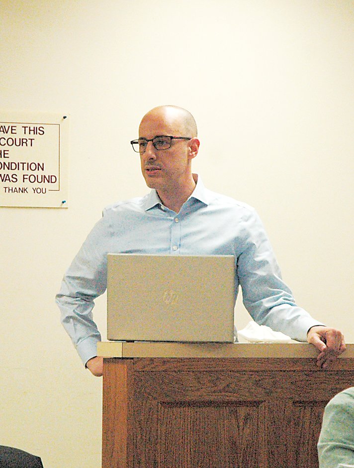 Alex Carmada, Director of State Government Affairs presented before the Town Board, speaking mainly on the details of the franchise agreement.