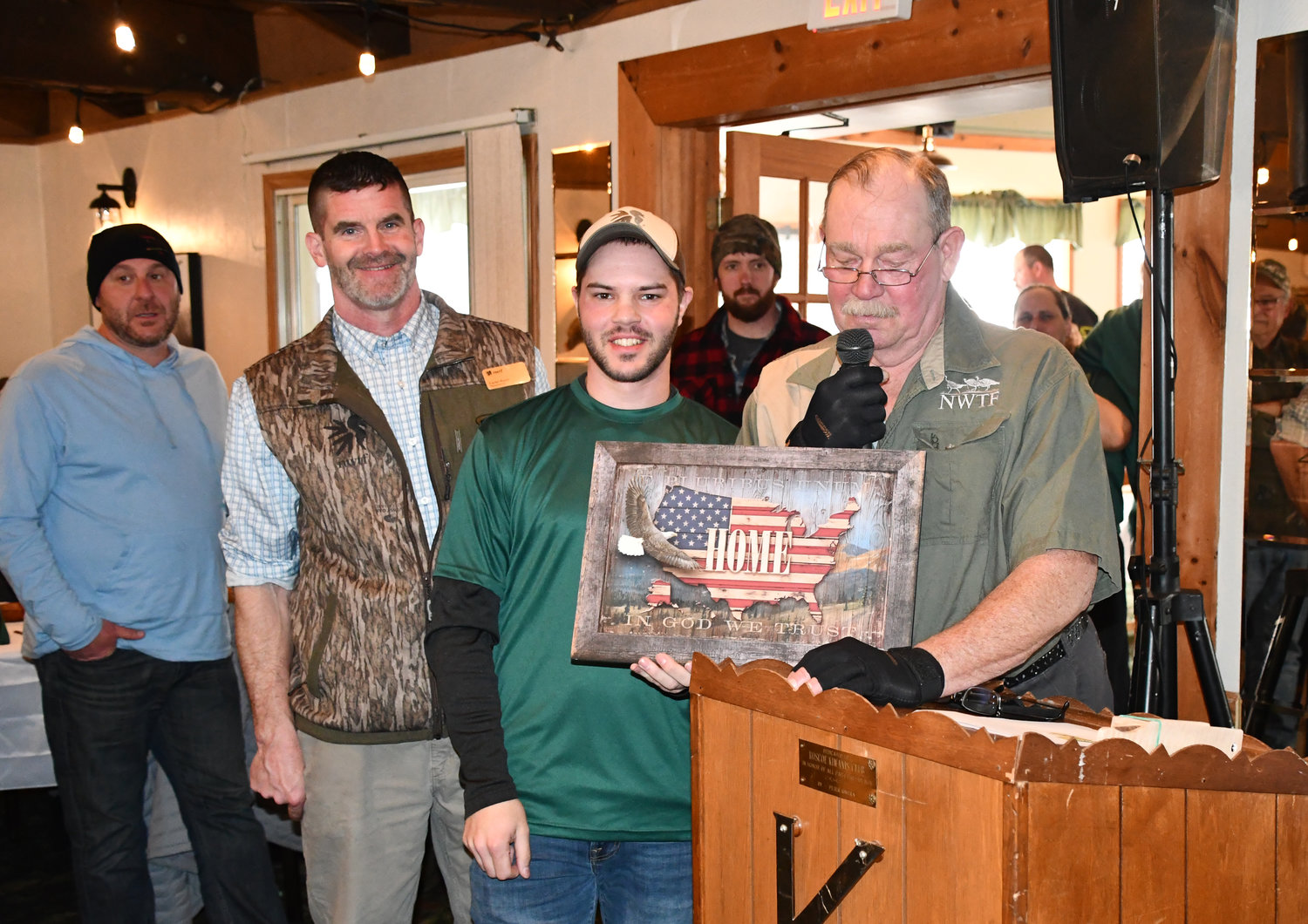 Regional Director of the Northeast and Eastern New York Wild Turkey Federation Carter Heath, left, joins volunteer Austin Zweck in honoring Chapter President Butch Kortright for his years of dedicated service to the Chapter.