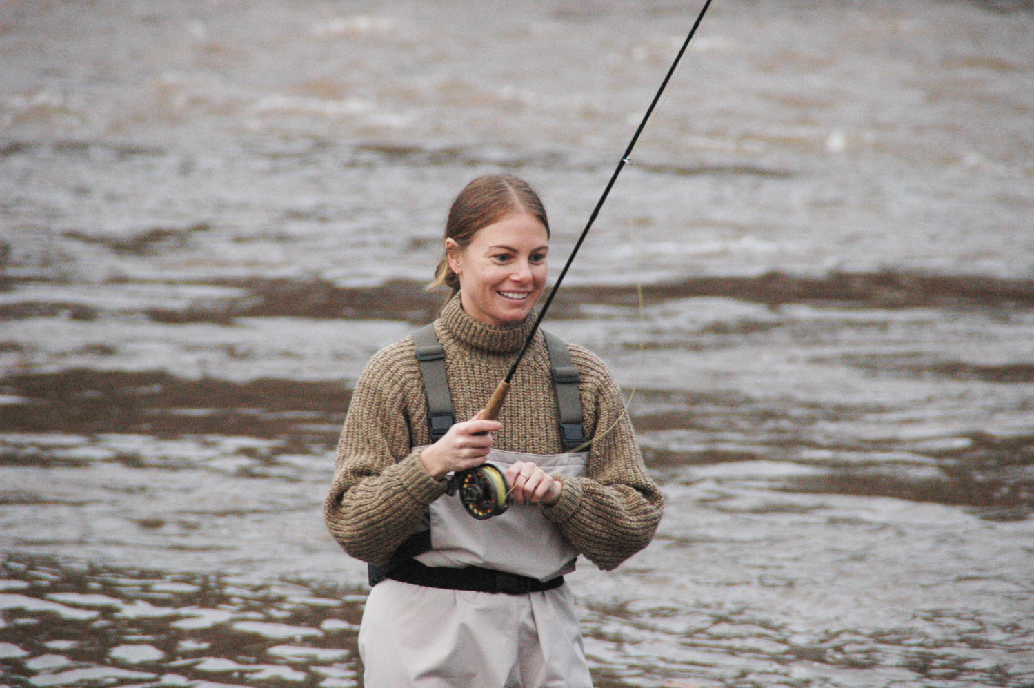 Rachael Yaeger is all smiles as she wades back in after the ceremonial First Cast of fishing season. The new owner of the Roscoe Motel was cheered on by friends, family and members of the community on Friday Morning.