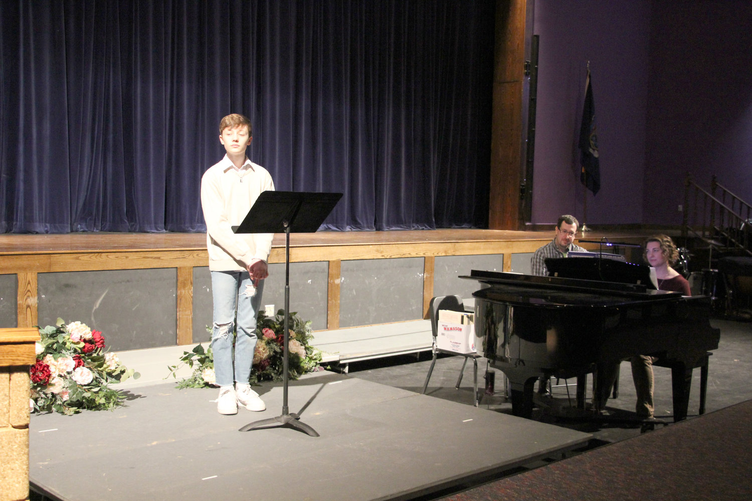 Logan Weyant sang “Break, O Sea.” At right, Keira Sullivan Weyant accompanies her son on piano. Music teacher Kevin Giroux is pictured also.