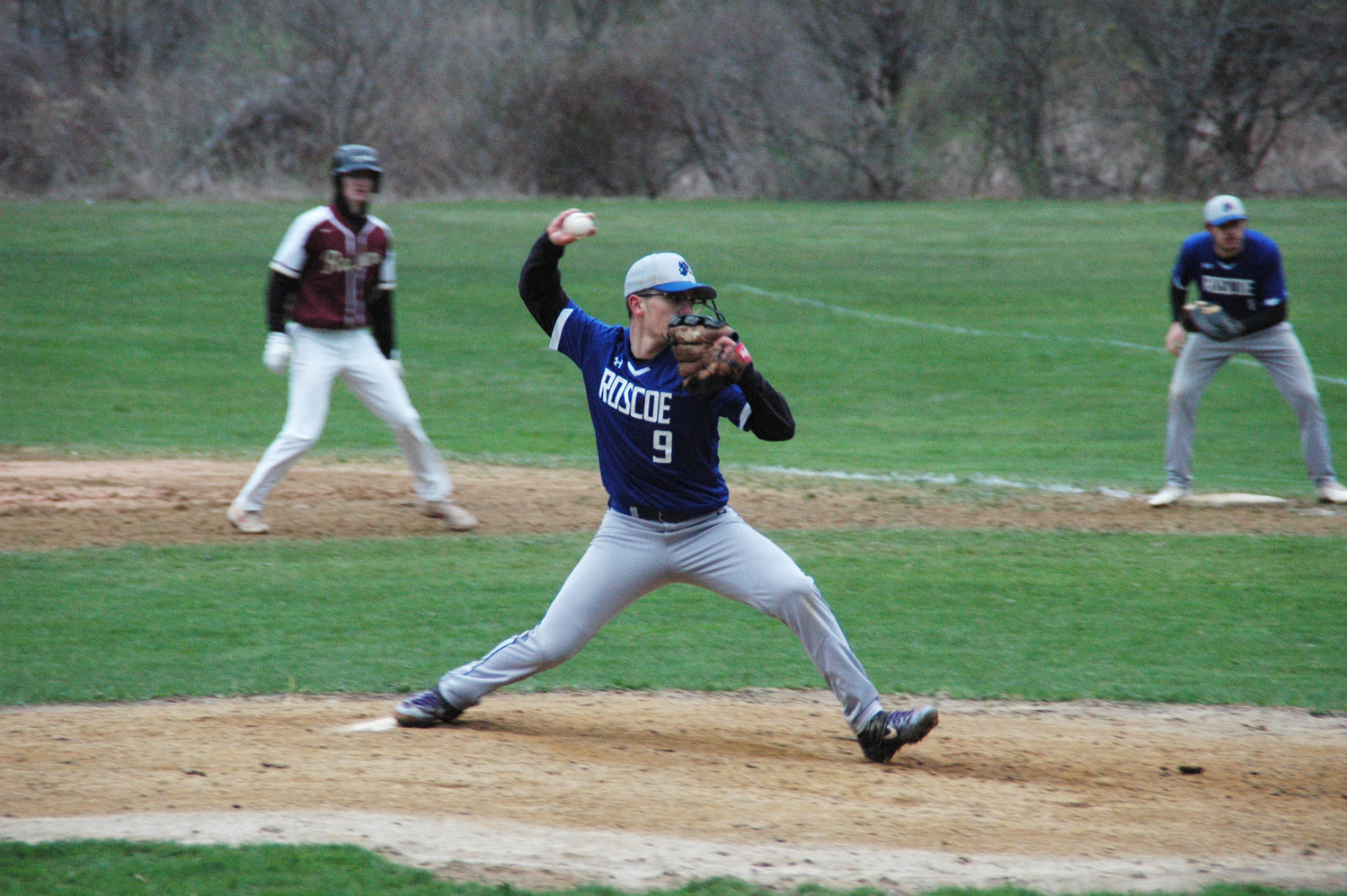 During a cold and windy home opener against O’Neill, Roscoe pitcher Paul Coman tried to bring the heat on the mound.