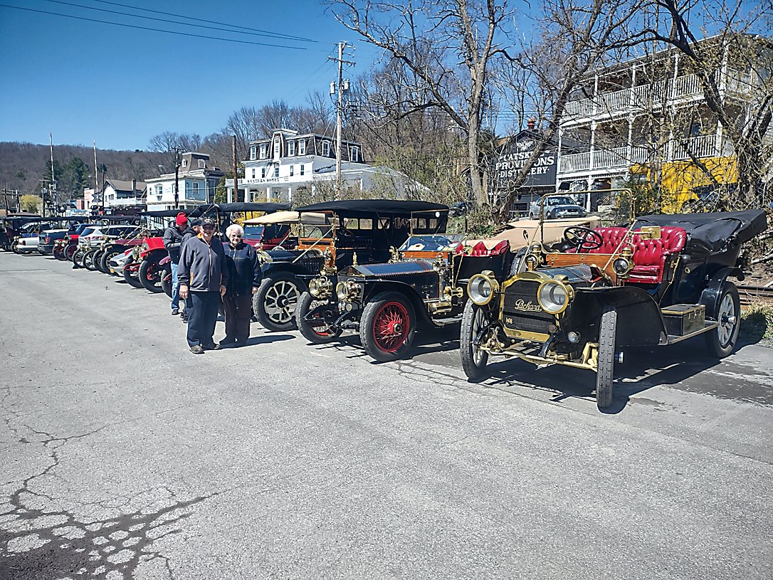 Sandy and Art Flynn, pictured at the center of the photo below, toured the unique collection of vehicles whose owners belong to the club Friends of Ancient Road Transportation (FARTS). The Club had been on a tour of the region starting at the Eldred Preserve. The collection included brands such as Locomobile, Packard, Oldsmobile, Buick, Rolls Royce, Mercedes Benz and more.