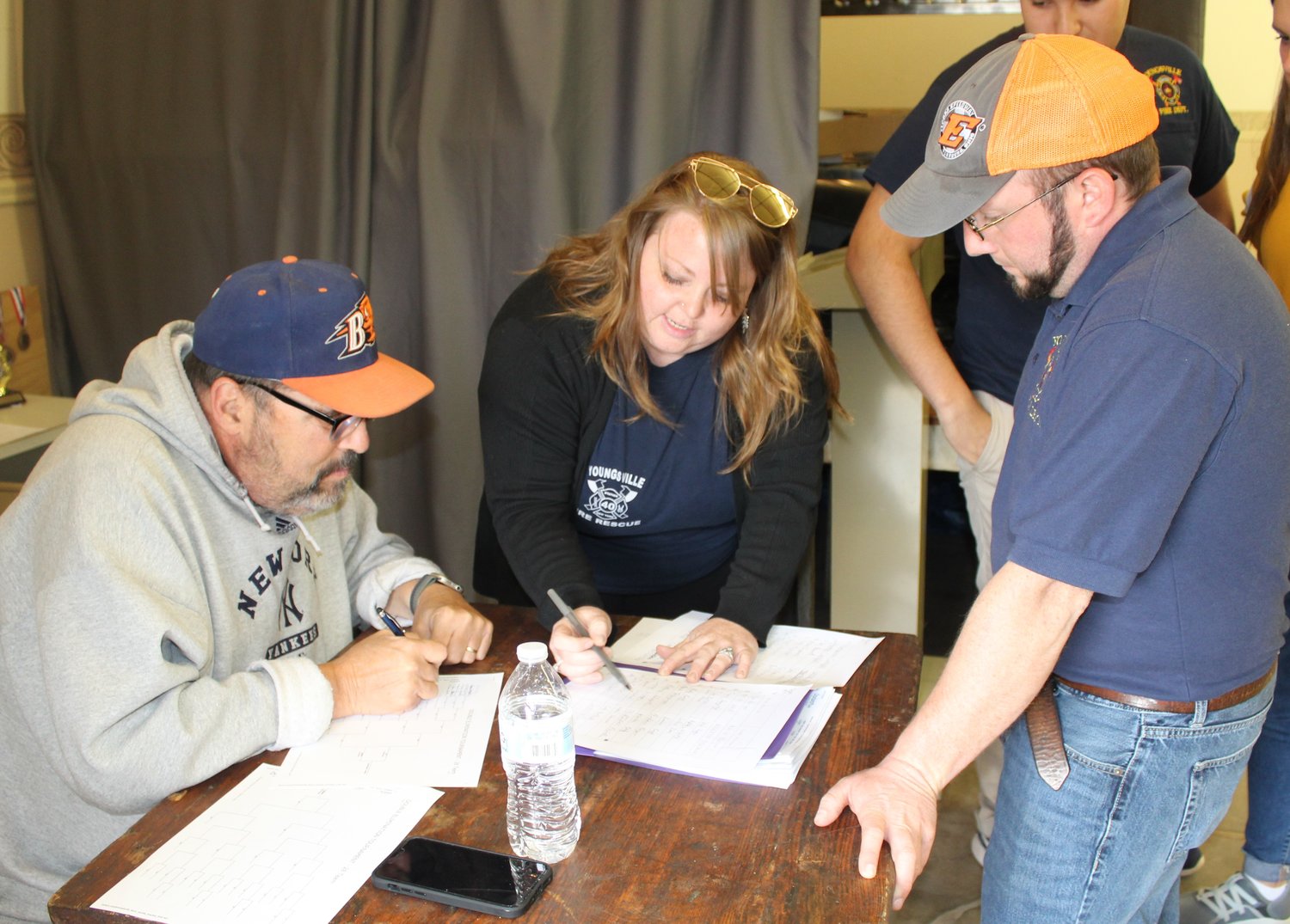 Behind the scenes of every successful event are volunteers who helped with the Youngsville Fire Department Cornhole Classic Tournament. They are, from the left, Rick Ellison, keeping the stats, Amber Creegan, helping with stats and Jonathan McGibbon, one of the tournament organizers.