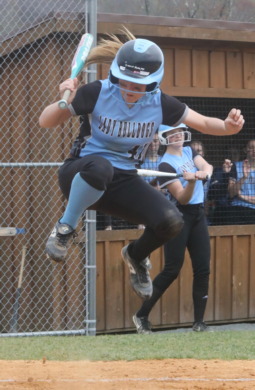 Sullivan West sophomore Elizabeth Reeves uses her quick reflexes to avoid a bouncing pitch in the first inning.