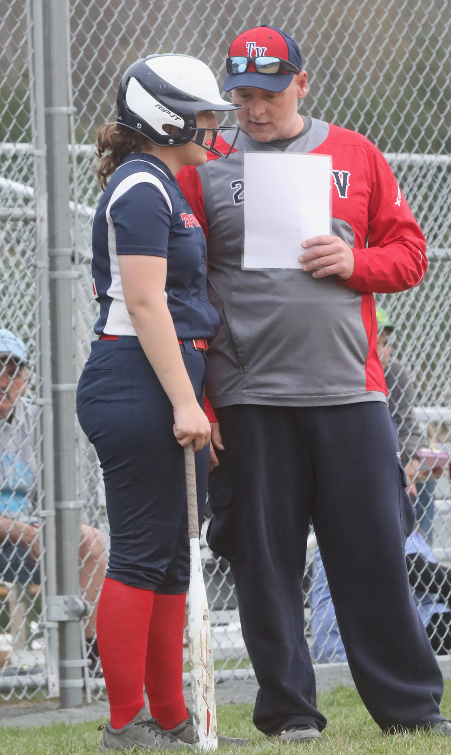 Tri-Valley assistant coaching guru John Rusin imparts some advice to his daughter Emily who went two-for-three on the day and drove in a pair of runs.