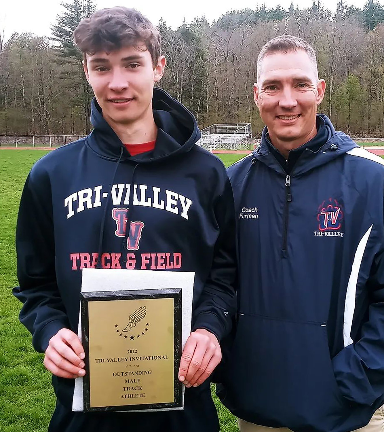 Tri-Valley’s Adam Furman poses with his dad and coach Chip after being named by the coaches at the meet as the Outstanding Male Track Athlete. He won the 400, 800 1600 and 3200.