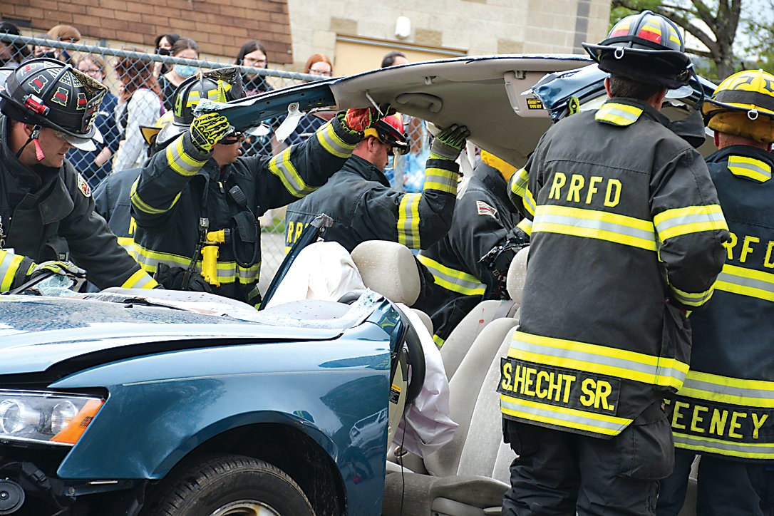 Roscoe-Rockland firefighters work to remove the roof of the vehicle hit by an “impaired driver,” in order to get to an “injured passenger.”