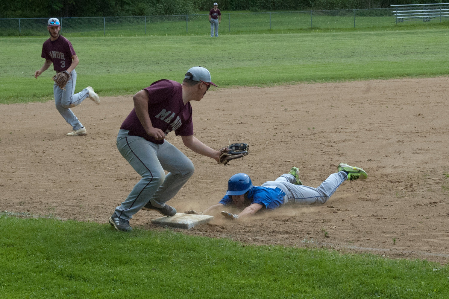 Roscoe Senior Jack Madera dives in just before a tag for a stolen base.