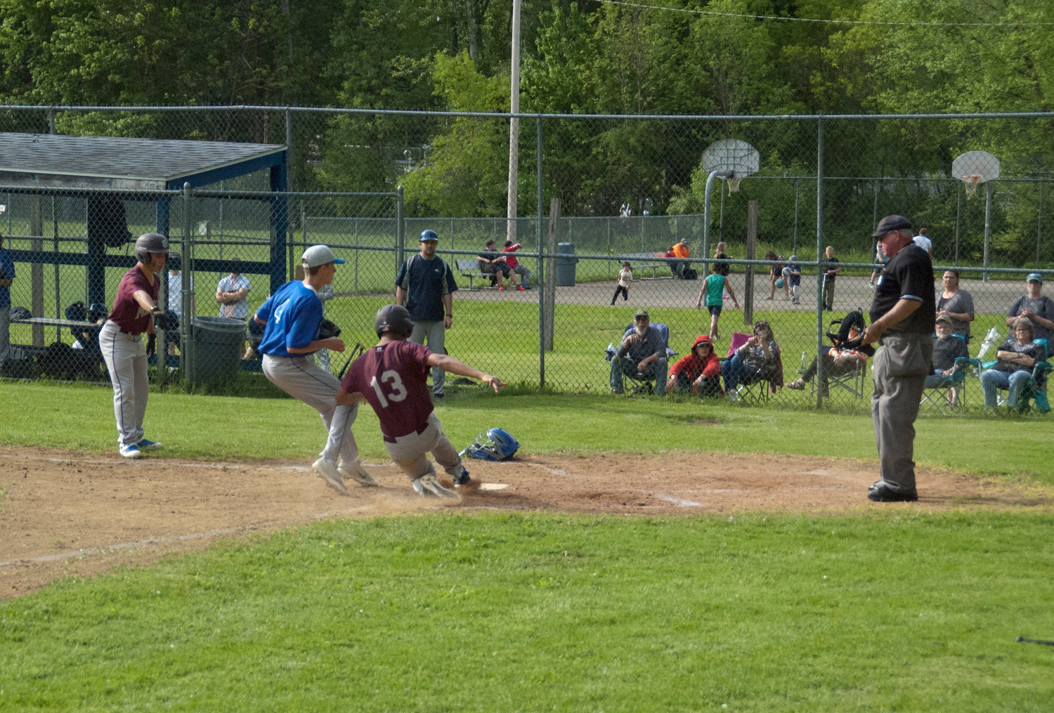 Wildcat Daniel Tolbert slides safely into home plate after advancing on a passed ball.