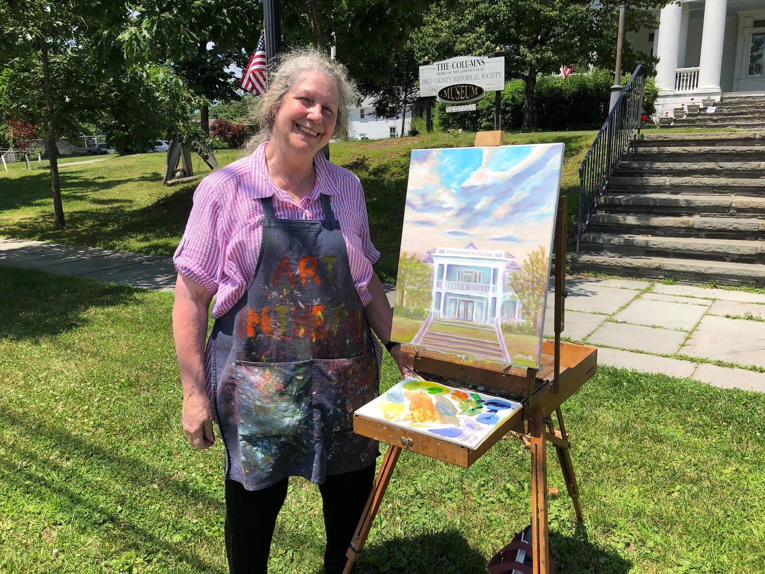 Artist Susan Miller and her 2019 painting of The Columns Museum