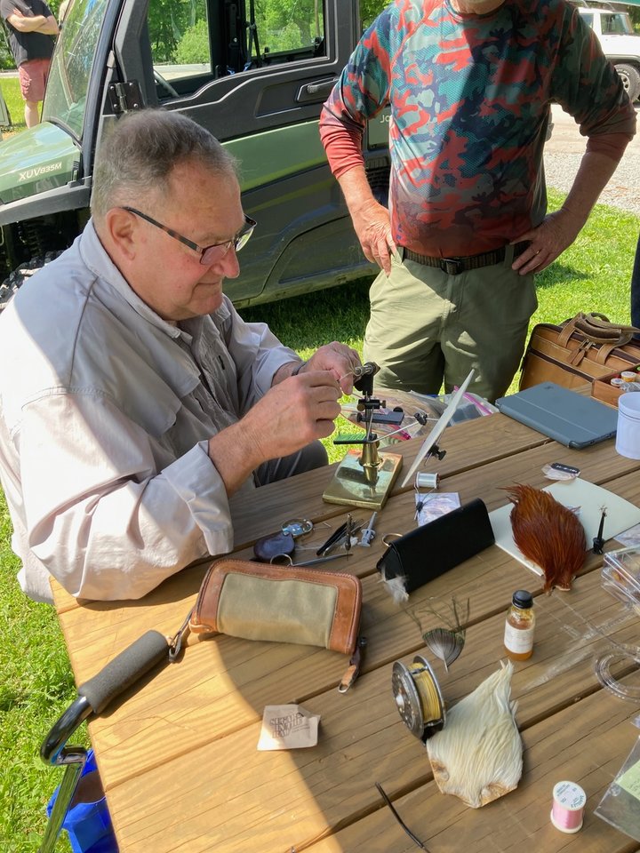 Tom Mason, member of the Catskill Fly Tiers Guild, uses some of Mahlon Davidson’s original materials to tie a fly at the celebration.