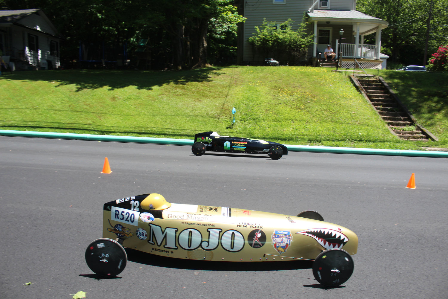 Mason Smith in his golden MOJO sponsored car races against Andrew Freidenstine in his car sponsored by Landscape by Design and Dick’s Auto Sales