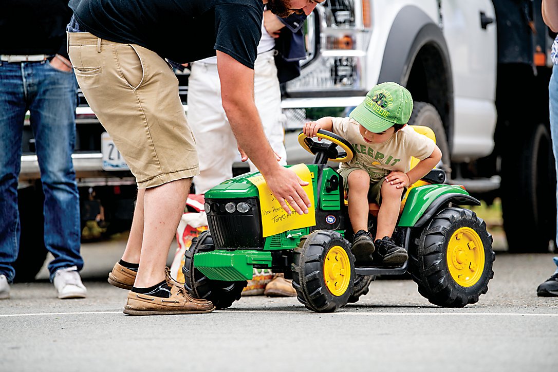 The tractor parade almost got a last minute addition ... almost! Little Henry Tonjes of Tonjes Farm in the Beechwoods got a little help affixing his tractor label before deciding maybe he'll wait until next year.