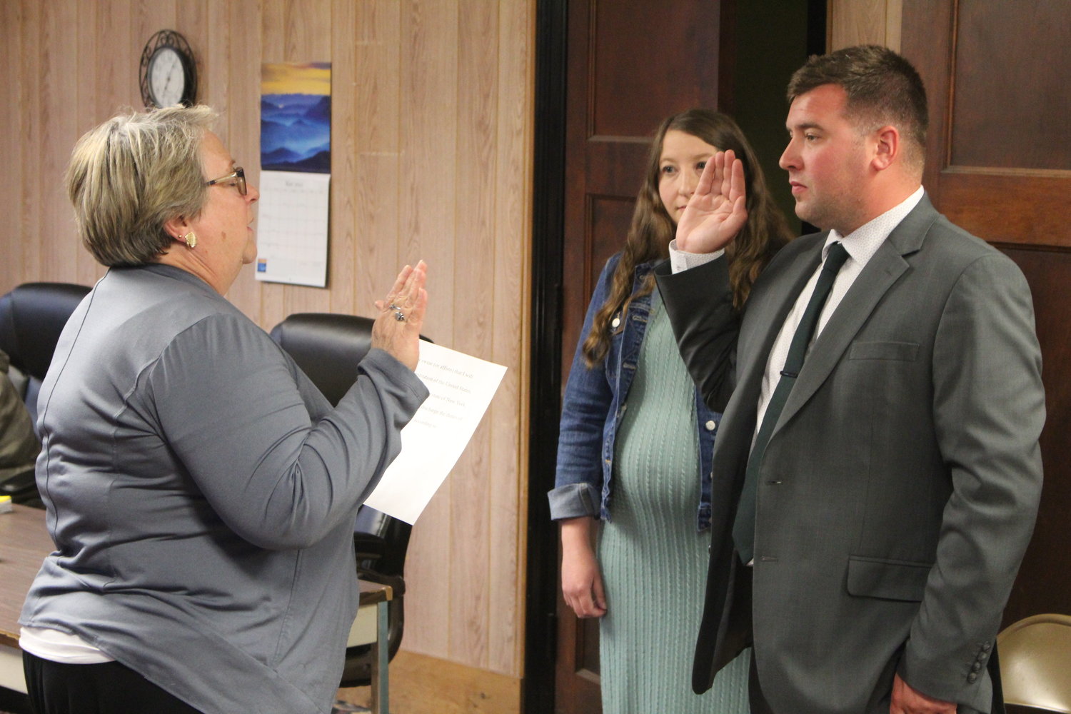 Police Detective Andrew Cross is sworn in by Village of Liberty Mayor Joan Stoddard alongside his wife Kaitlyn.