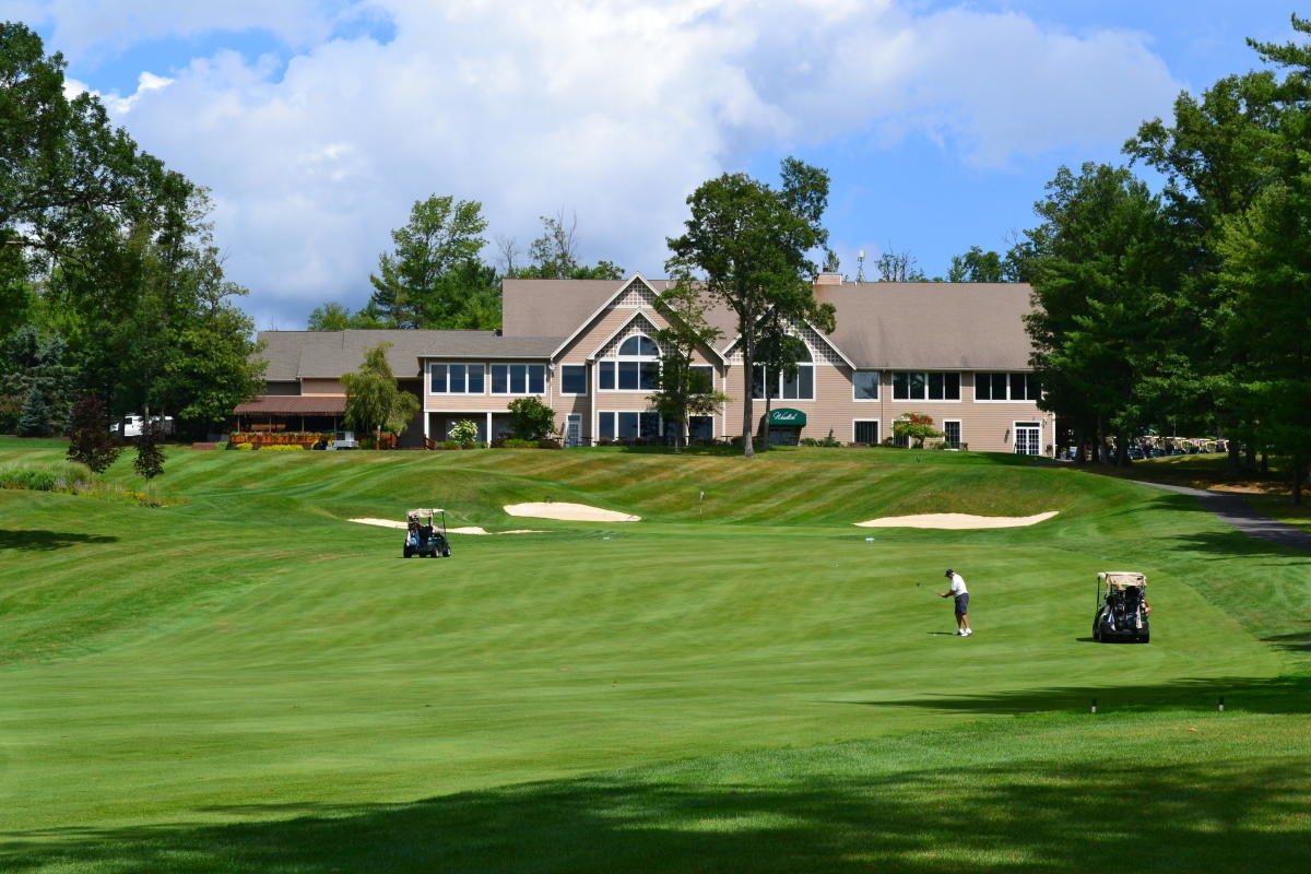 Approaching the 18th  green at The Country Club at Woodloch Springs with the beautifully designed clubhouse in the background. The golf course at Woodloch Springs is a family friendly course dedicated to growing the game.